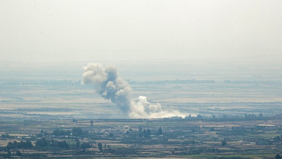 epa06894537 Smoke rises after a Russian air strike on the Syrian side of the Golan Heights in Quneitra province, as seen from the Israeli side of the border, 17 July 2018. According to reports, Syrian ...