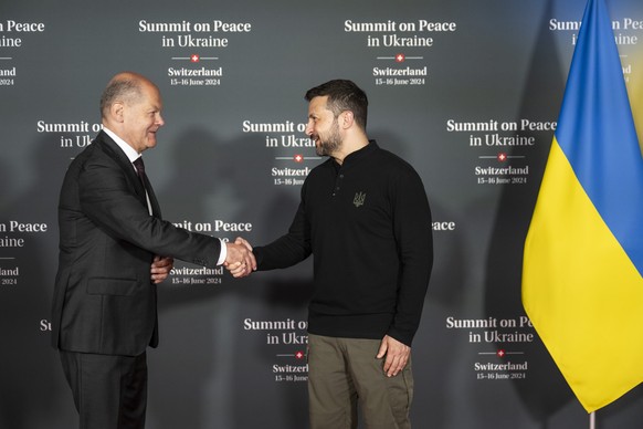 epa11414083 Ukrainian President Volodymyr Zelenskyy (R) welcomes Federal Chancellor Olaf Scholz of Germany during the Summit on Peace in Ukraine, in Stansstad near Lucerne, Switzerland, 15 June 2024.  ...