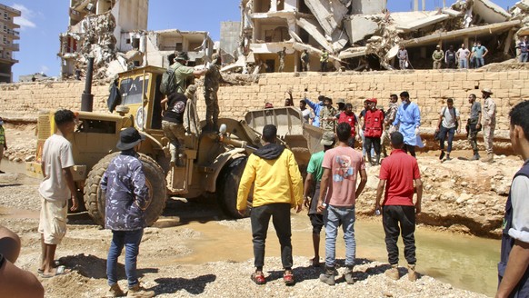 People look for survivors in Derna, Libya, Wednesday, Sept.13, 2023. Search teams are combing streets, wrecked buildings, and even the sea to look for bodies in Derna, where the collapse of two dams u ...