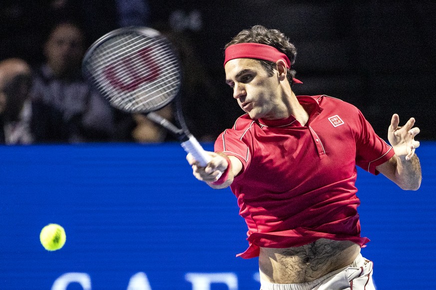 Roger Federer of Switzerland returns a ball to Alex De Minaur of Australia during their final match at the Swiss Indoors tennis tournament at the St. Jakobshalle in Basel, Switzerland, on Sunday, Octo ...