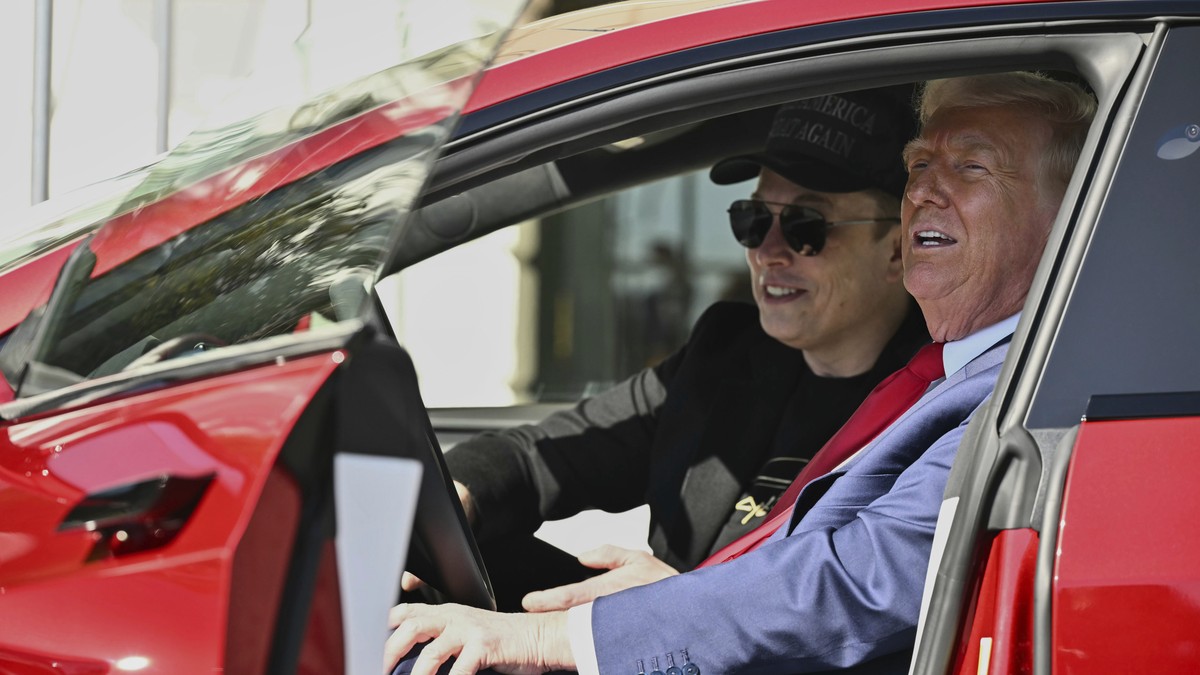 FILE - President Donald Trump and Tesla CEO Elon Musk speak to reporters as they sit in a red Model S Tesla vehicle on the South Lawn of the White House, March 11, 2025, in Washington. (Pool via AP, F ...
