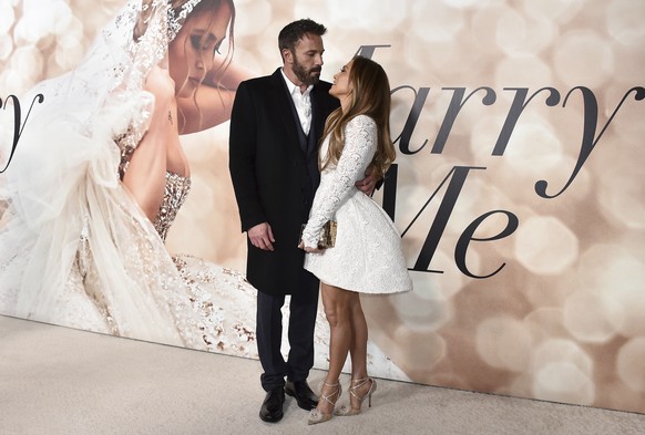 FILE - Cast member Jennifer Lopez, right, and Ben Affleck attend a photo call for a special screening of &quot;Marry Me&quot; at DGA Theater on Feb. 8, 2022, in Los Angeles. The couple have obtained a ...
