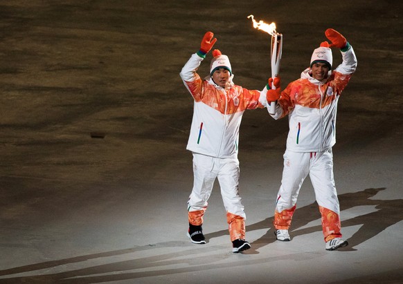 epa06591369 A handout photo made available by the Olympic Information Service of the International Olympic Committee of athletes Choi Bogue (L) of South Korea and Ma Yu-chol (R) of North Korea during  ...