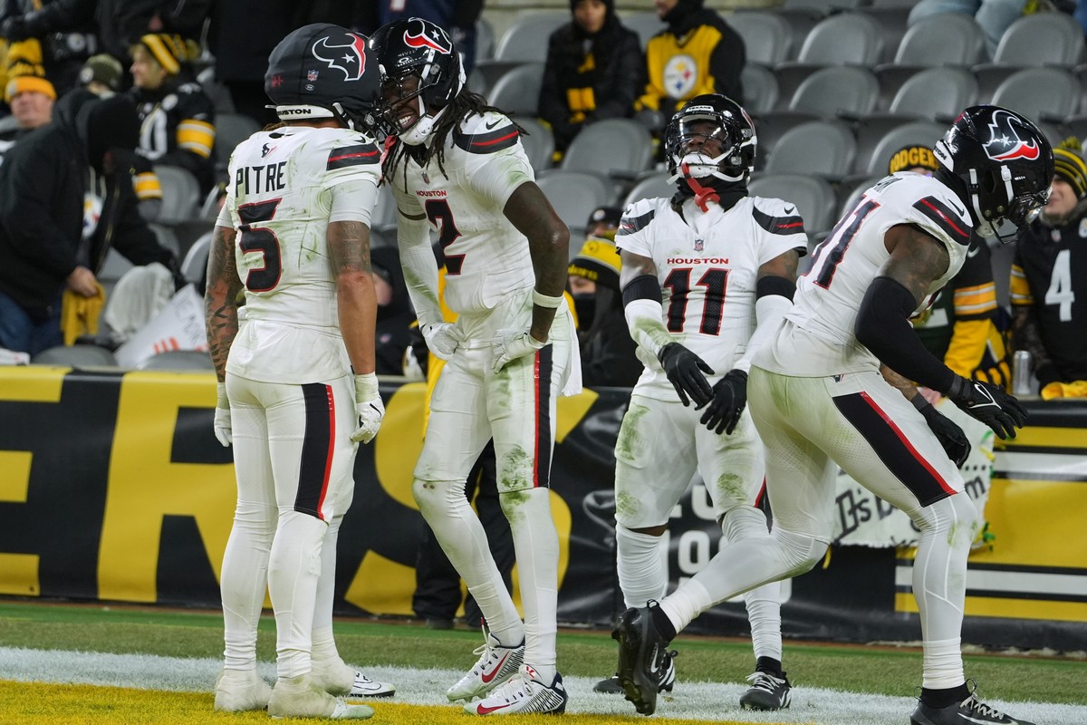 Houston Texans safety Calen Bullock (2) celebrates with safety Jalen Pitre (5) after running back an interception for a touchdown during the second half of NFL wild-card playoff football game against  ...