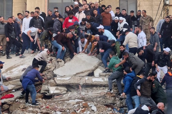 Rescue workers and residents search for survivors in the rubble of a building that collapsed in the northern city of Tripoli, Lebanon, Sunday, Feb. 8, 2026. (AP Photo)