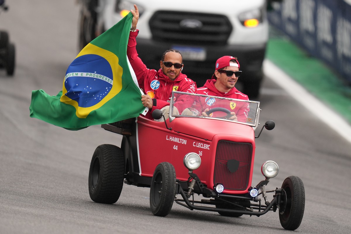 Ferrari driver Lewis Hamilton of Britain, left, and Ferrari driver Charles Leclerc of Monaco wave to the crowd during the opening parade at the Brazilian Formula One Grand Prix at the Interlagos race  ...