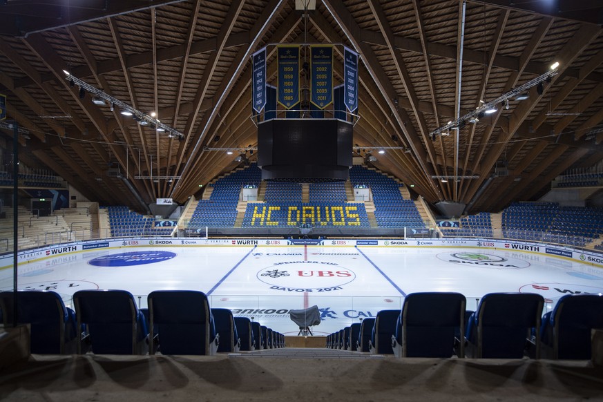 epa09656467 A covered TV camera stands among empty stands at the ice stadium in Davos, Switzerland, 25 December 2021. The 94th Spengler Cup was canceled one day before the start of the traditional tou ...