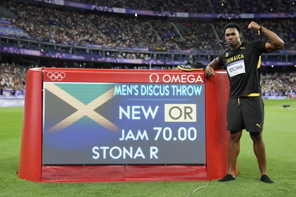 Roje Stona, of Jamaica, celebrates after winning the men&#039;s discus throw final at the 2024 Summer Olympics, Wednesday, Aug. 7, 2024, in Saint-Denis, France. (AP Photo/Matthias Schrader)