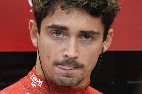 Ferrari driver Charles Leclerc of Monaco waits inside their garage during the second practice session of the Singapore Formula One Grand Prix at the Marina Bay Street Circuit, in Singapore, Friday, Se ...