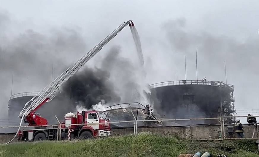 epa10598083 A still image taken from a handout video made available by the Governor of Sevastopol&#039;s Telegram channel shows firefighters deployed to extinguish a fire at an oil depot in Sevastopol ...