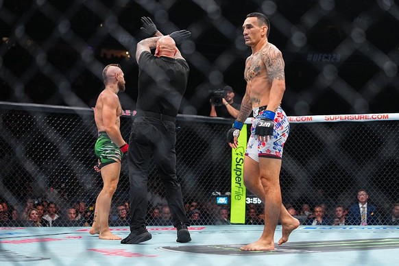 LAS VEGAS, NEVADA - JULY 11: Referee Mike Beltran stops the match between (L-R) Conor McGregor of Ireland and Max Holloway in a welterweight fight during the UFC 329 event at T-Mobile Arena on July 11 ...