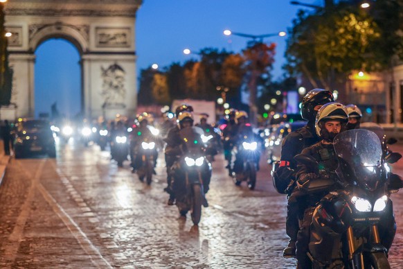 epa10723152 Riot police forces on motorbike secure the area in front of the Arc de triomphe amid fears of another night of clashes with protestors in Paris, France, 02 July 2023. Violence broke out al ...