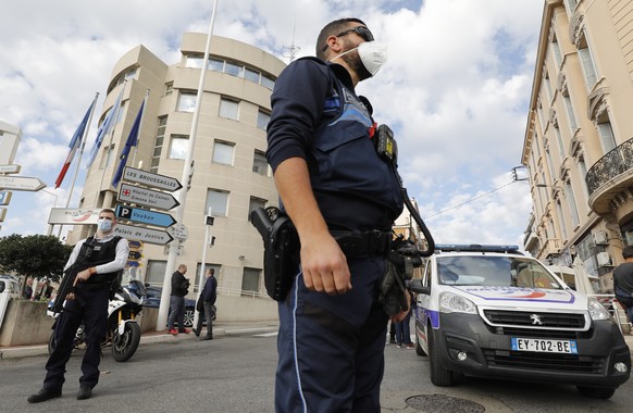 epa09570921 French police officers stand at a security perimeter following a knife attack in Cannes, France, 08 November 2021. According to French Internior Minister Gerald Darmanin, one police office ...