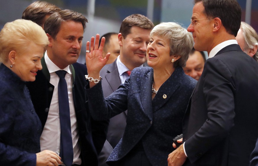 British Prime Minister Theresa May, center, speaks with Dutch Prime Minister Mark Rutte, right, and /Lithuanian President Dalia Grybauskaite, left, during a round table meeting at an EU summit in Brus ...