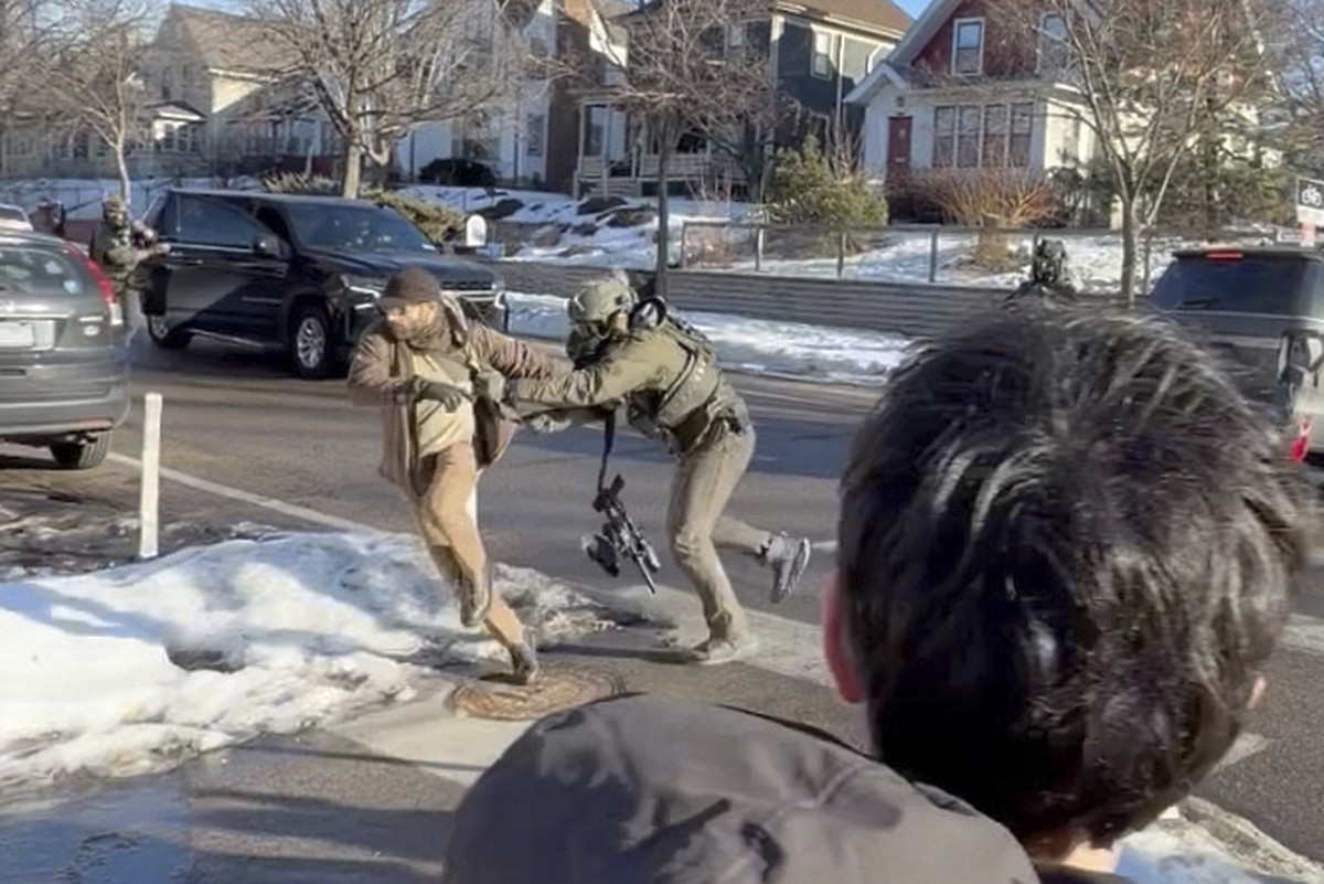 This image taken from video by Max Shapiro shows Alex Pretti, left, scuffling with federal immigration officers in Minneapolis on Jan. 13, 2026. (Max Shapiro via AP)
Alex Pretti