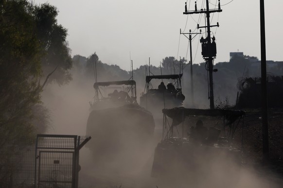 epaselect epa11007279 Israeli armoured vehicles maneuver at a position near the border with the Gaza Strip, in southern Israel, 02 December 2023. The IDF announced on 02 December they struck over 400  ...