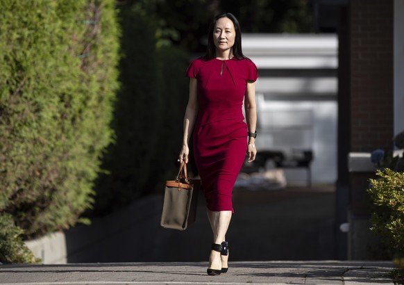 Meng Wanzhou, chief financial officer of Huawei, leaves home to attend her extradition hearing at B.C. Supreme Court, Tuesday, Aug. 10, 2021, in Vancouver, British Columbia. (Darryl Dyck/The Canadian  ...