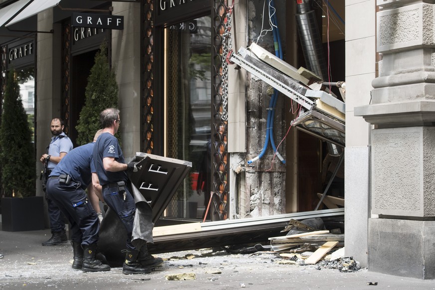 Polizisten sichern den Bereich nach einem Ueberfall auf ein Juweliergeschaeft am Samstag, 28. Mai 2016, in Zuerich. An der Zuercher Bahnhofstrasse haben Rammbock-Raeuber am Samstagmittag ein Juwelierg ...