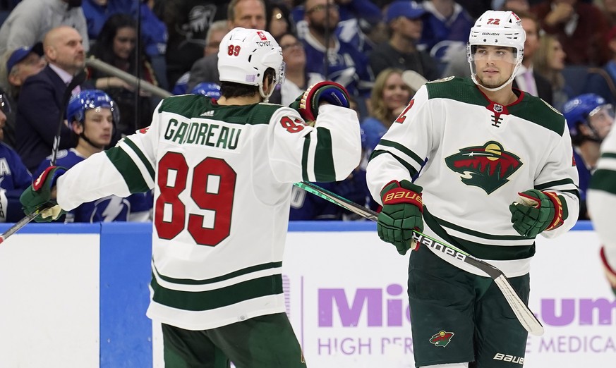Minnesota Wild left wing Kevin Fiala (22) celebrates his goal against the Tampa Bay Lightning with center Frederick Gaudreau (89) during the third period of an NHL hockey game Sunday, Nov. 21, 2021, i ...