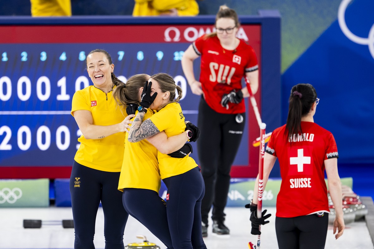 Gold medalists Agnes Knochenhauer, Sara McManus and Sofia Mabergs of Sweden, from left to right, celebrate next to Alina Paetz and Carole Howald of Switzerland during the women's curling gold med ...