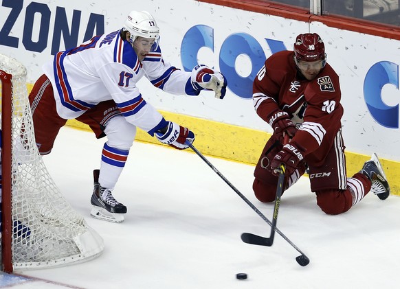 Arizona Coyotes left wing Martin Erat (10) centers the puck against New York Rangers defenseman John Moore during the first period of an NHL hockey game, Saturday, Feb. 14, 2015, in Glendale, Ariz. (A ...