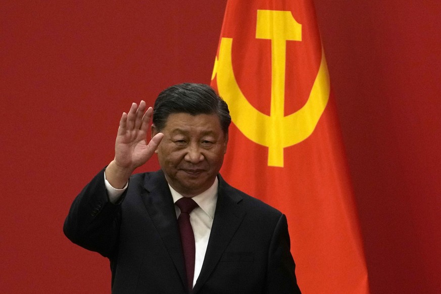 Chinese President Xi Jinping waves at an event to introduce new members of the Politburo Standing Committee at the Great Hall of the People in Beijing, Sunday, Oct. 23, 2022. (AP Photo/Andy Wong)