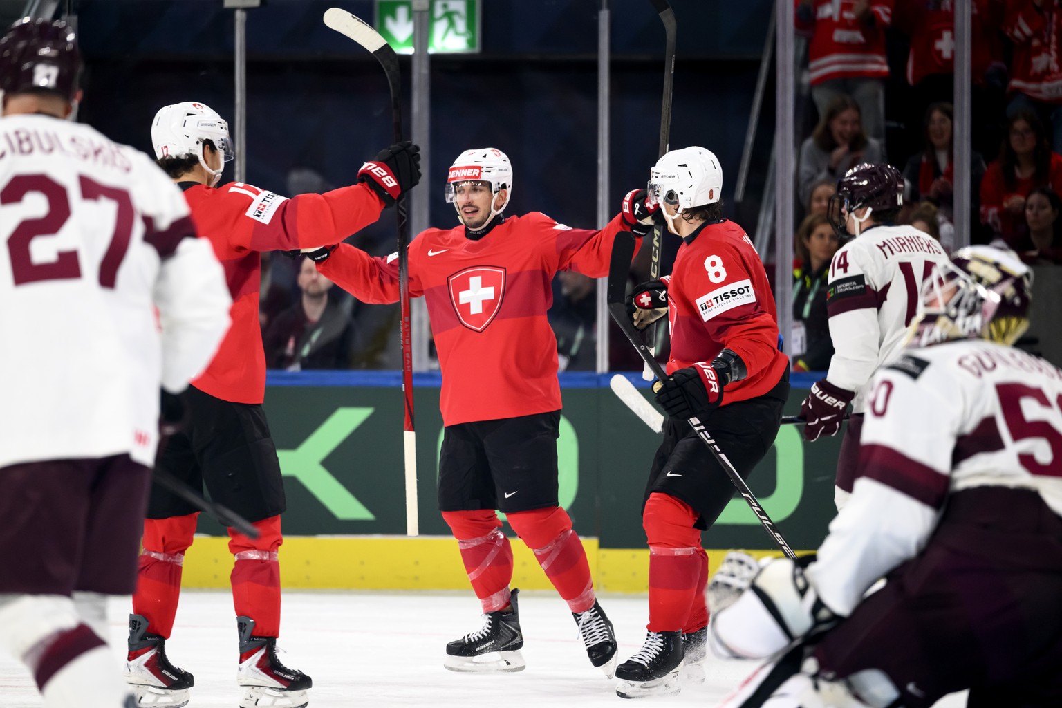 KEYPIX - From left, Switzerland's Ken Jager, Switzerland's Damien Riat and Switzerland's Simon Knak celebrate the fourth goal during the 2026 IIHF Men's Ice Hockey World Championsh ...