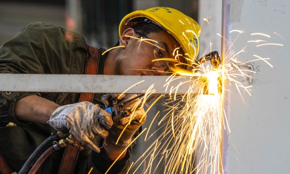 epa07961957 A man works in the Sany Heavy Industry factory in Changsha, Hunan province, China, 19 October 2019 (issued 31 October 2019). China&#039;s manufacturing purchasing managers&#039; index (PMI ...