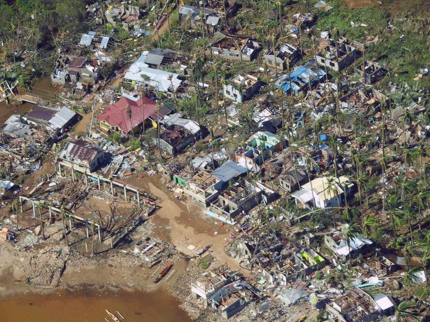 epa09647612 A handout picture made available by the Philippine Coast Guard (PCG) shows an aerial view of a typhoon affected village in Surigao City, southern Philippines, 17 December 2021 (issued on 1 ...