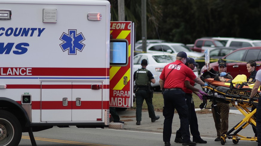 A person is transported from scene of a shooting, Friday, Nov. 2, 2018, in Tallahassee, Fla. A shooter killed one person and critically wounded four others at a yoga studio in Florida&#039;s capital b ...