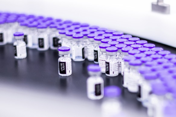 In this March 2021 photo provided by Pfizer, vials of the Pfizer-BioNTech COVID-19 vaccine are prepared for packaging at the companyÄôs facility in Puurs, Belgium. Pfizer is about to seek U.S. author ...