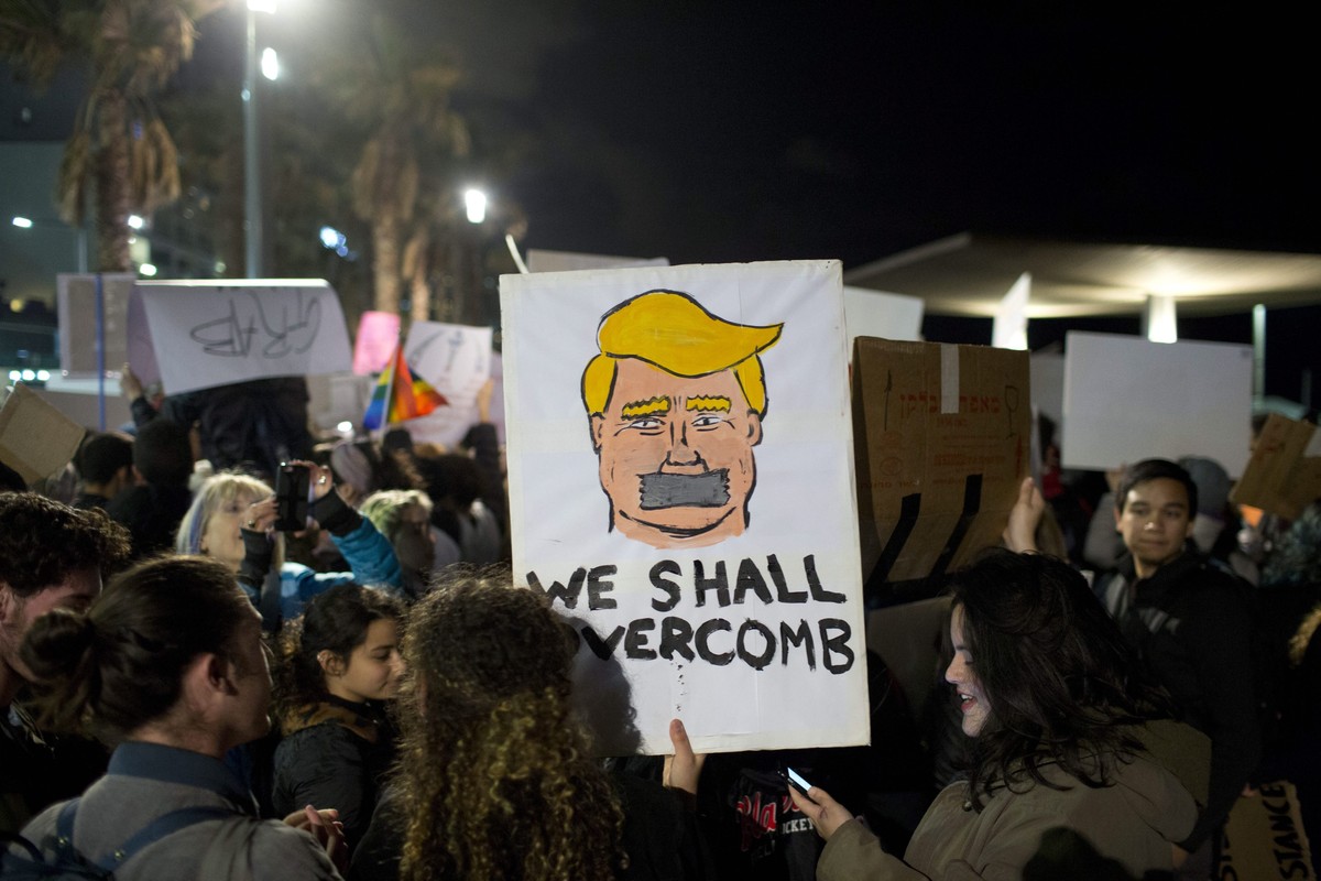 epa05739705 People attend the Women March, protesting for women's rights in front of the US Embassy in Tel Aviv, Israel, 21 January 2017. Protest rallies were held in over 30 countries around the ...