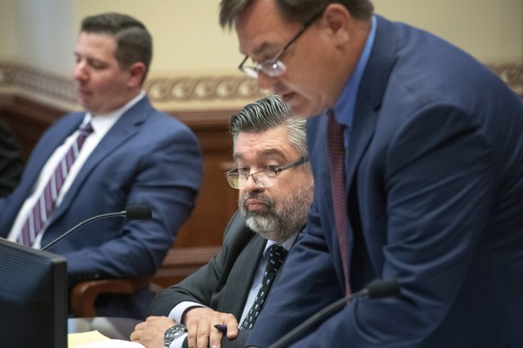 David Warrington, center, and Theodore Boecker, right, lawyers representing Charles Herbster; and David Lopez, left, a lawyer representing State Sen. Julie Slama, are seen in court, June 14, 2022, in ...