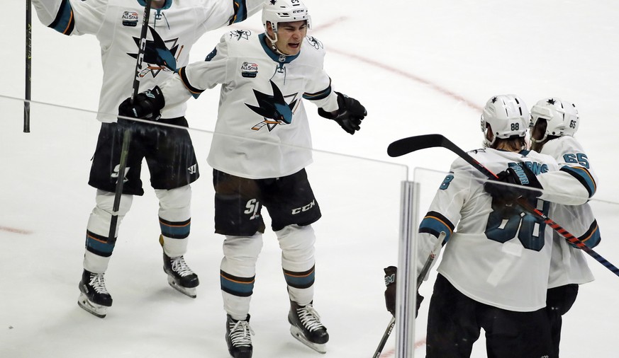 San Jose Sharks defenseman Brent Burns (88) celebrates with Joonas Donskoi, left; Timo Meier, of Switzerland, second from left; and Erik Karlsson (65), of Sweden; after Burns scored the winning goal i ...