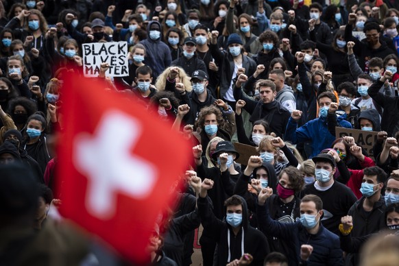 People demonstrate against racism during a protest in Lausanne, Switzerland, Saturday, 13 June 2020. Worldwide protests continue to take place prompted by the death last month of George Floyd by police officers in Minneapolis, USA that has led to protests in many countries and across the US calling for an end to racial injustice. (Jean-Christophe Bott/Keystone via AP)