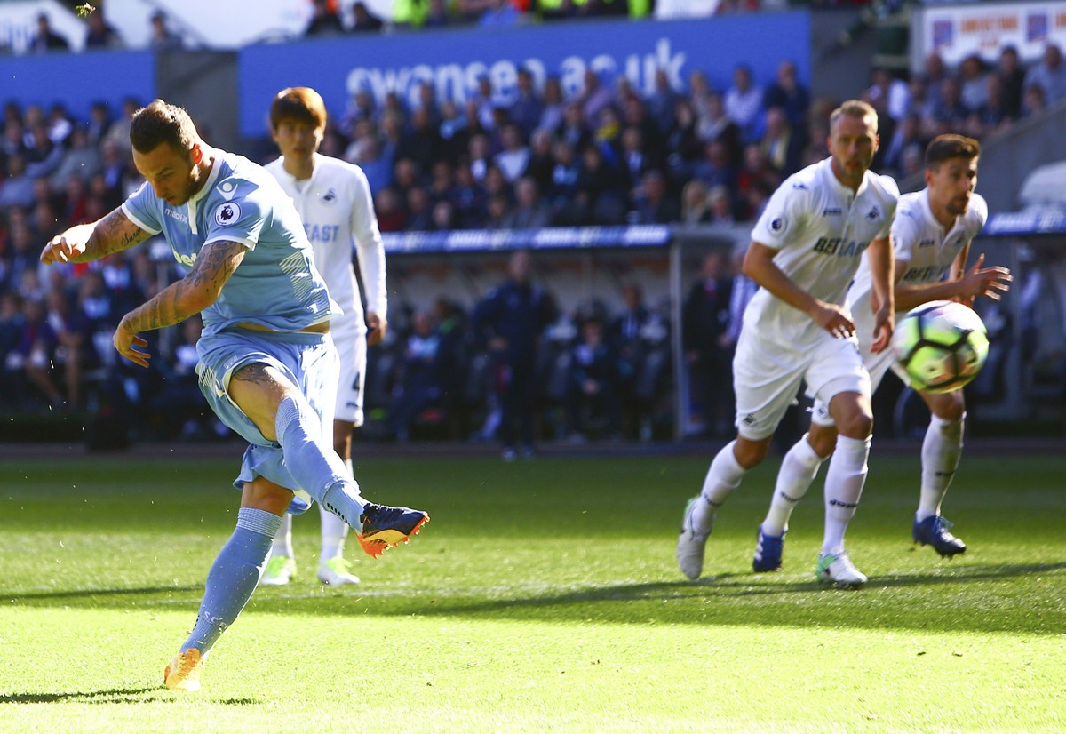 Stoke City's Marko Arnautovic,left, misses a penalty during the English Premier League soccer match against Swansea City at the Liberty Stadium, Swansea, England, Saturday, April 22, 2017. (Geoff ...