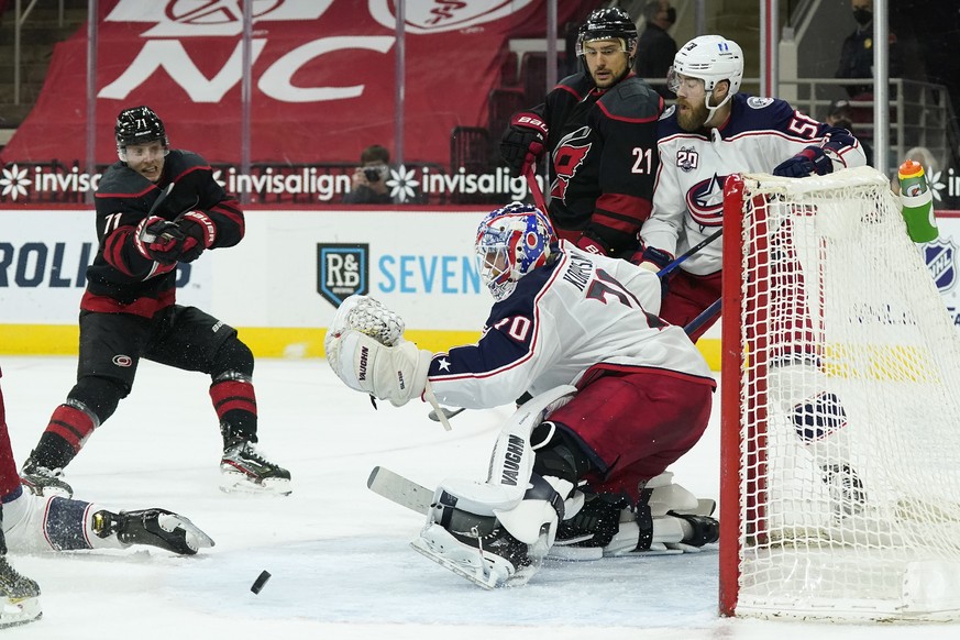 Carolina Hurricanes right wing Jesper Fast (71), of Sweden, tries to score against Columbus Blue Jackets goaltender Joonas Korpisalo (70), of Finland, as Carolina Hurricanes right wing Nino Niederreit ...