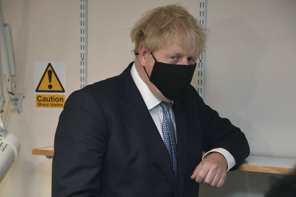 Britain's Prime Minister Boris Johnson gestures during a visit to Tollgate Medical Centre in Beckton, East London, Friday July 24, 2020. (Jeremy Selwyn/Pool Photo via AP)