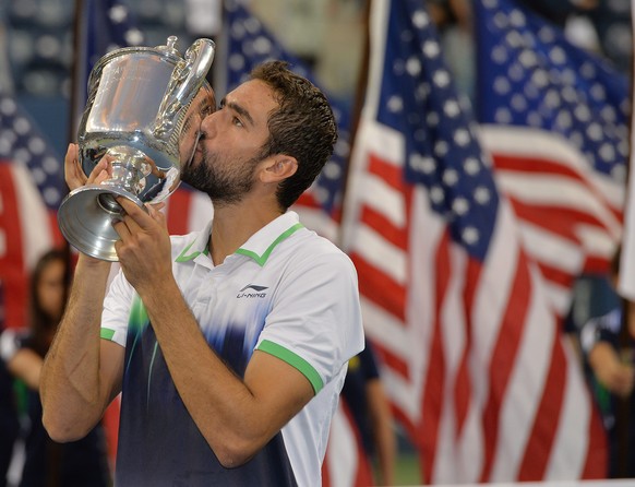 epa04391863 Marin Cilic of Croatia reacts with the championship trophy after defeating Kei Nishikori of Japan to win the men&#039;s final match on the fifteenth day of the 2014 US Open Tennis Champion ...