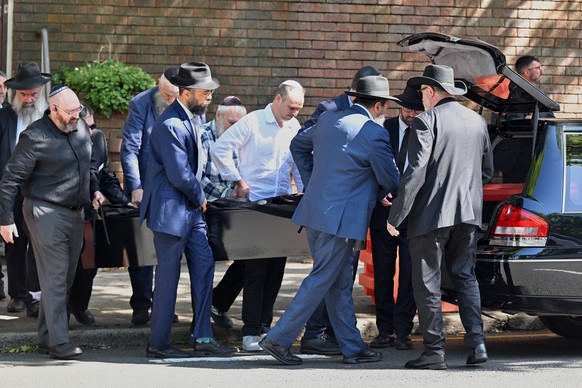 The casket is carried out during the funeral for Holocaust survivor and Bondi shooting victim, Alex Kleytman at Chevra Kadisha in Sydney, Thursday, Dec. 18, 2025. (Dean Lewins/AAP Image via AP)
Austra ...