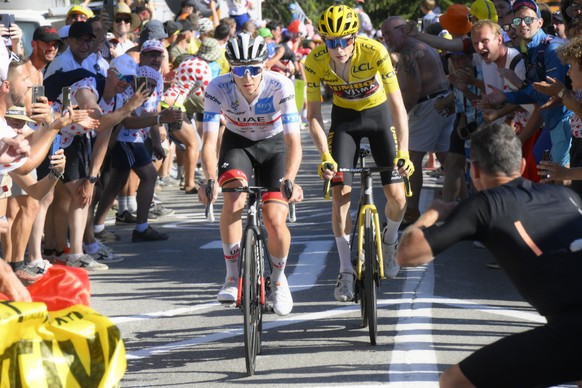 epa10071226 Yellow Jersey Danish rider Jonas Vingegaard (R) of Jumbo Visma and Slovenian rider Tadej Pogacar of UAE Team Emirates in action during the 12th stage of the Tour de France 2022 over 165.1k ...