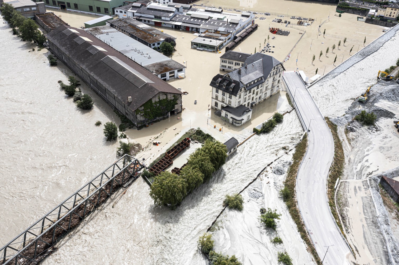 A view of the Rhone river, at left, and the Navizence river overflowing in the industrial zone that produces aluminium &quot;Constellium,&quot; following the storms that caused major flooding, in Chip ...