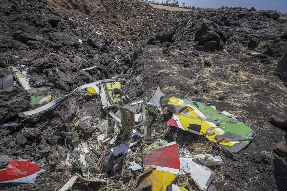 Wreckage lies at the scene of an Ethiopian Airlines flight that crashed shortly after takeoff at Hejere near Bishoftu, or Debre Zeit, some 50 kilometers (31 miles) south of Addis Ababa, in Ethiopia Su ...