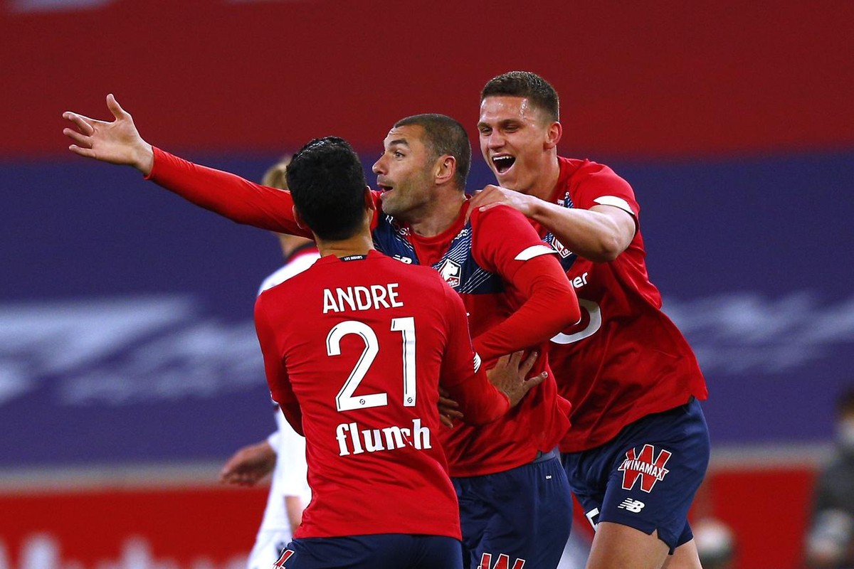 Lille's Burak Yilmaz, center, reacts after scoring during their French League One soccer match between Lille and Nice in Villeneuve d'Ascq, northern France, Saturday May. 1, 2021. (AP Photo/ ...