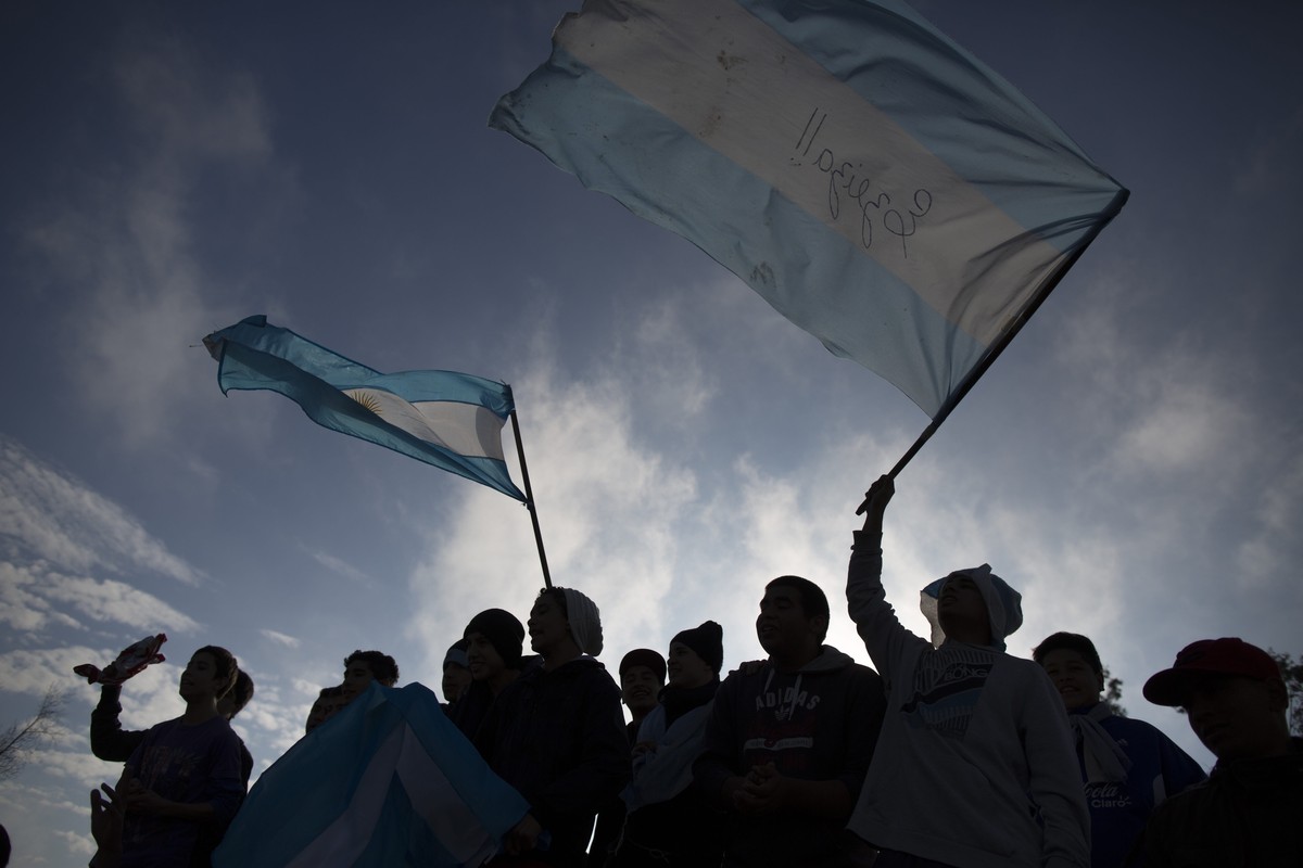 Argentina soccer fans wave flags as they wait for the arrival of Argentina's team to the airport in Buenos Aires, Argentina, Monday, July 14, 2014. Fans came out to welcome home Argentina's  ...