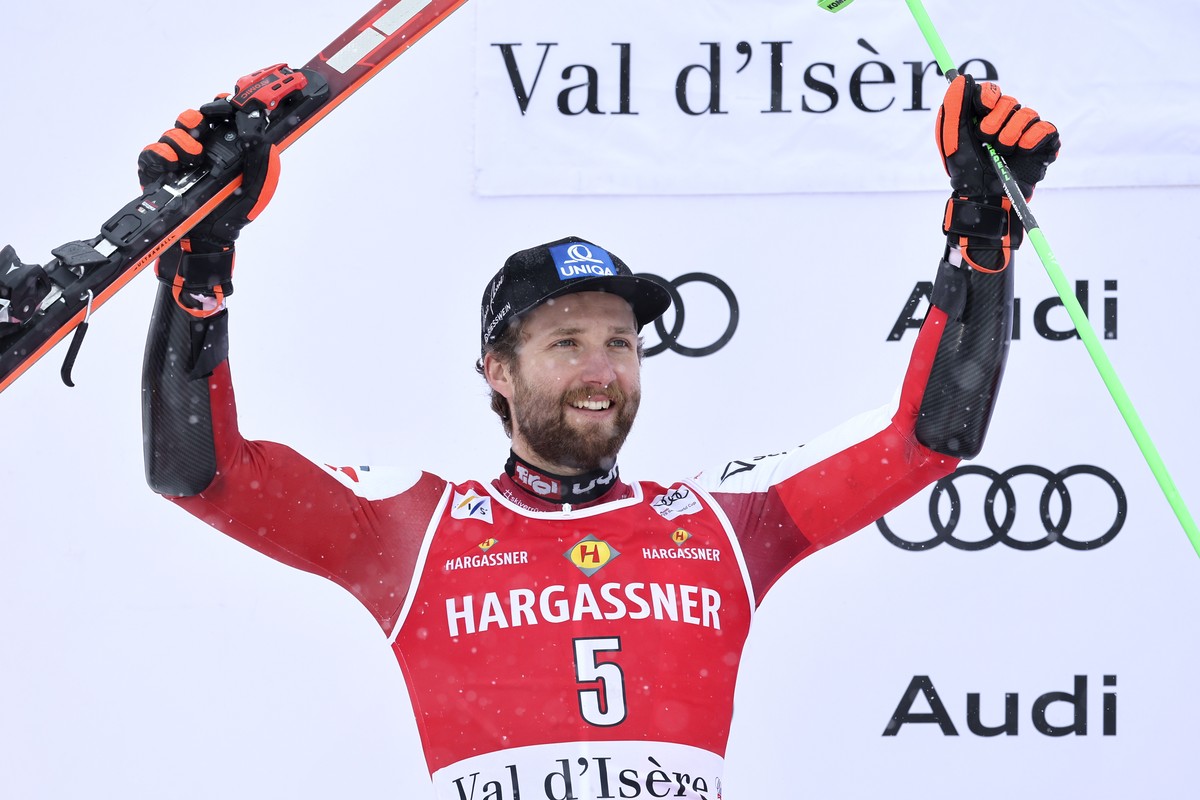 Austria's Marco Schwarz celebrates on the podium after taking taking second place in an alpine ski, men's World Cup giant slalom race, in Val d'Isere, France, Saturday, Dec.9, 2023. (AP ...