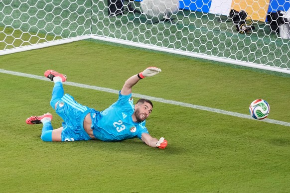 A shot by Jordan's Nizar Alrashdan, not visible, gets by Algeria goalkeeper Luca Zidane (23) for Jordan's first goal during the World Cup Group J soccer match between Jordan and Algeria in S ...