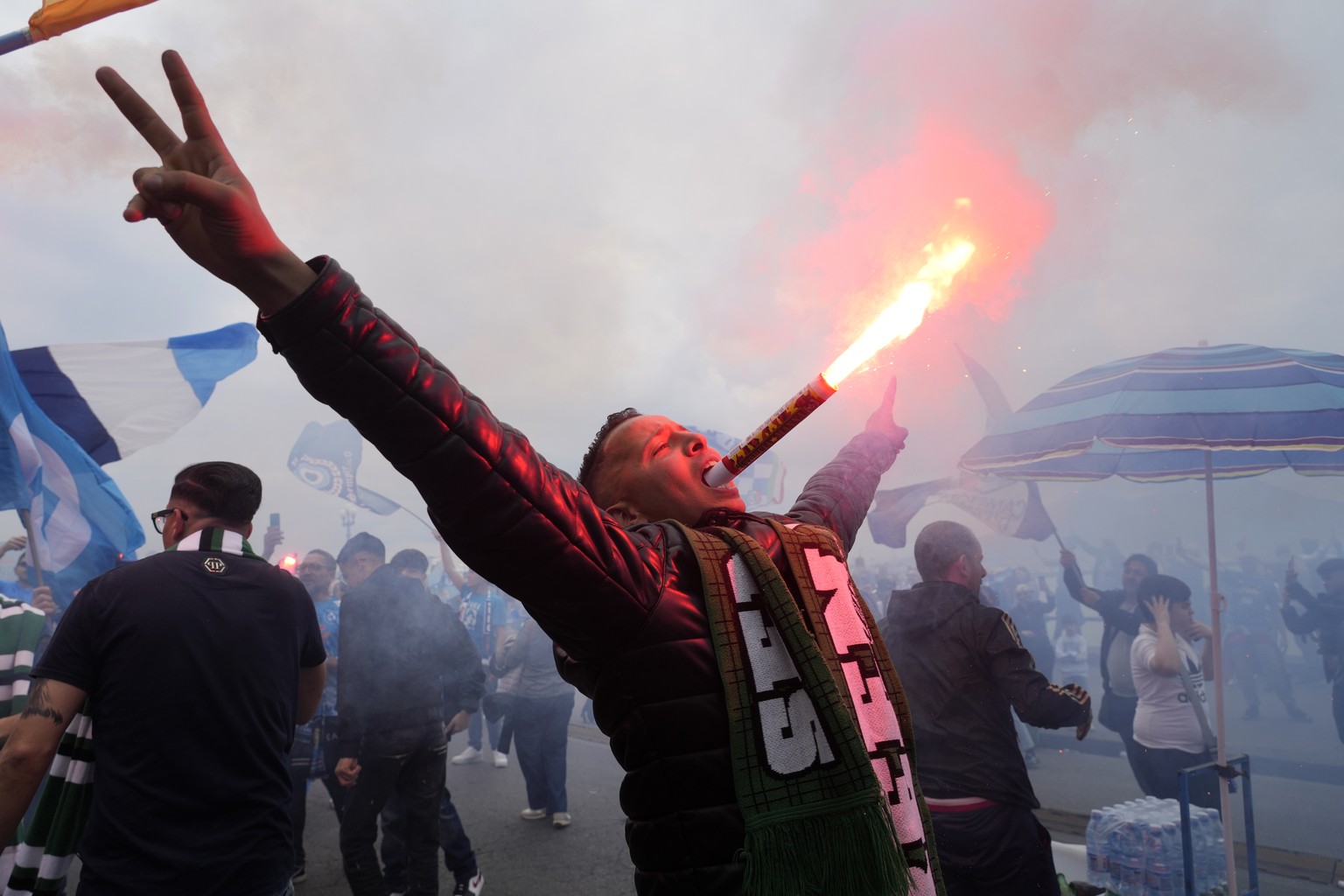 Napoli fans celebrates on the street after their team scored the first goal during the Serie A soccer match between Napoli and Salernitana at the Diego Armando Maradona stadium, in Naples, Italy, Sund ...