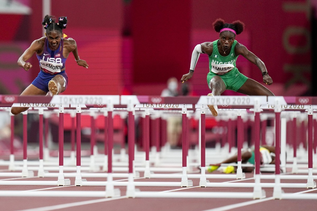 Christina Clemons of the United States and Tobi Amusan, right, of Nigeria, compete in a women's 100-meter hurdles semifinal at the 2020 Summer Olympics, Sunday, Aug. 1, 2021, in Tokyo. (AP Photo/ ...