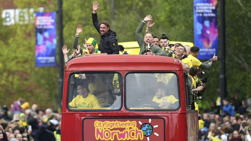 Norwich City manager Daniel Farke and players celebrate on a bus during a promotion parade, in Norwich City Centre, in Norwich, England, Monday May 6, 2019. Having already secured promotion to the Pre ...